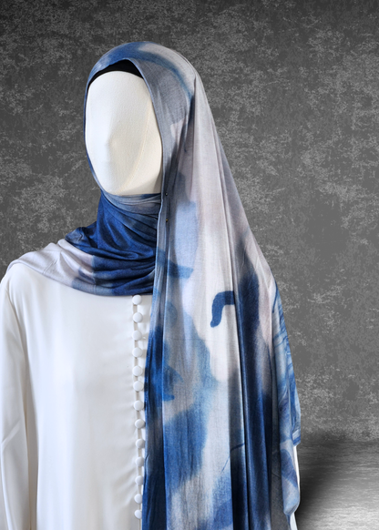 Discover the Celestial Tide Printed Jersey Hijab. A dreamy blue watercolor design on breathable, 4-way stretch fabric. Soft, stylish, and perfect for every day.