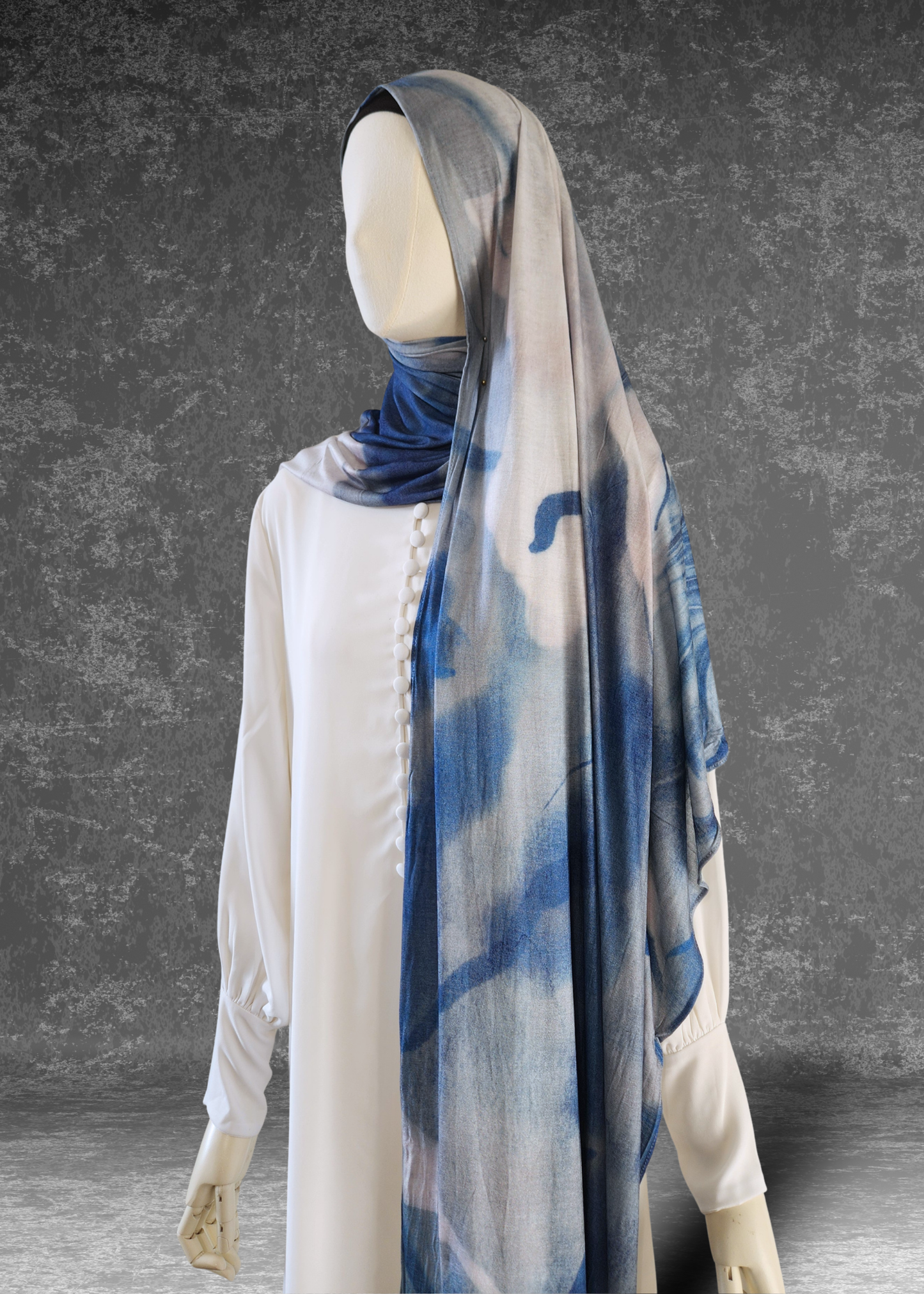 Discover the Celestial Tide Printed Jersey Hijab. A dreamy blue watercolor design on breathable, 4-way stretch fabric. Soft, stylish, and perfect for every day.